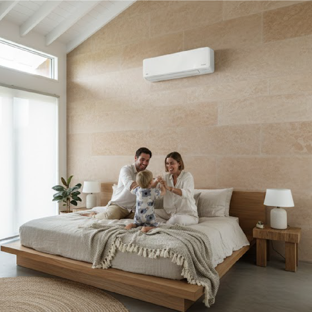 Wall mounted air conditioner on a stone wall in a minimalist bedroom.